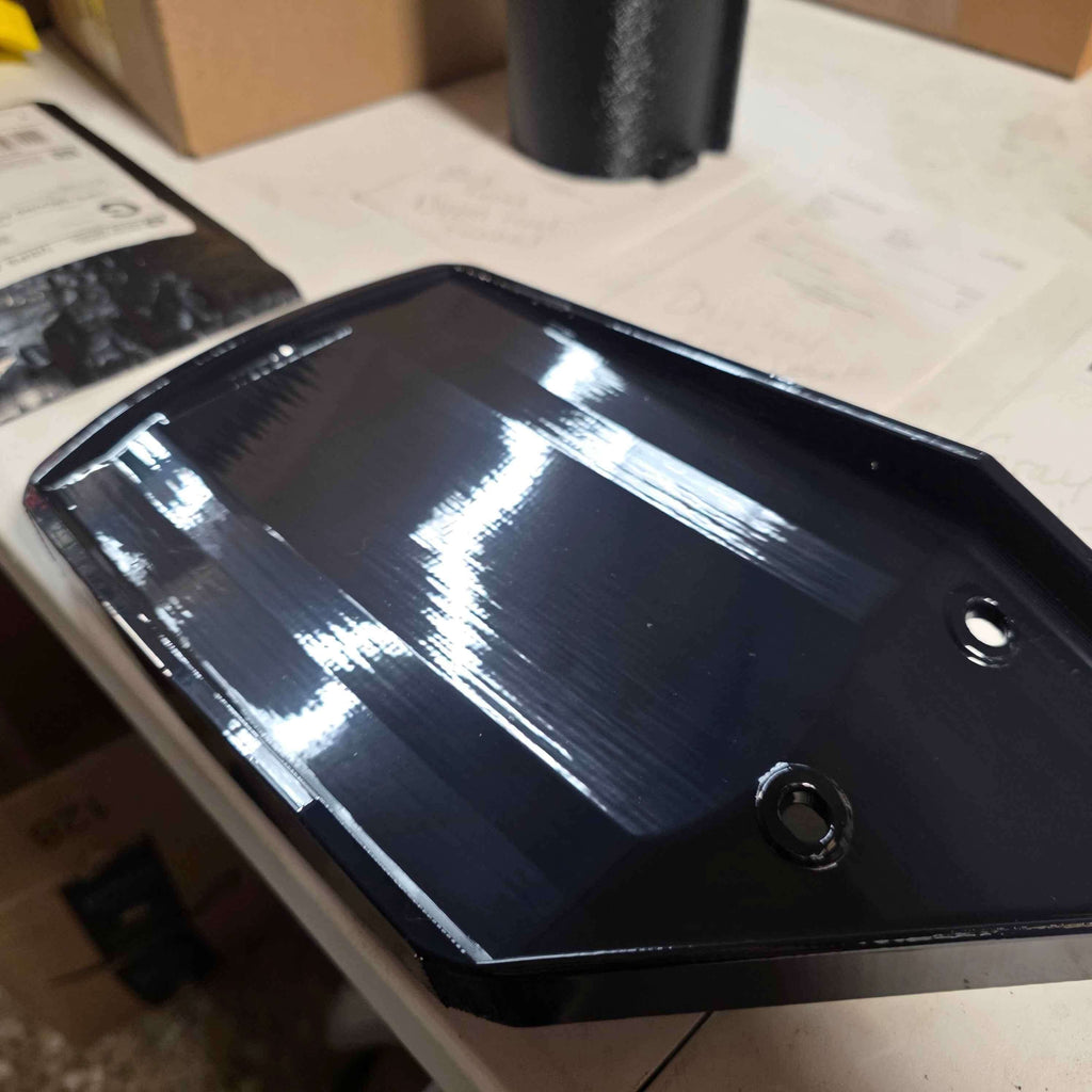 Factory Drain Tray for F-150 & Expedition 20152025 showing glossy black design and pre-drilled holes for installation.